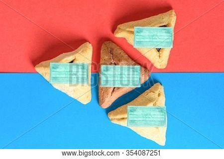 Purim And Coronavirus.hamantash Cookies For Jewish Holiday Purim Wearing Face Mask. Concerts, Sporti