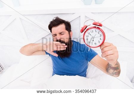 Need To Sleep Longer. Man Hipster Want To Sleep. Male On Bed Yawning. Mute The Alarm Clock. The Morn
