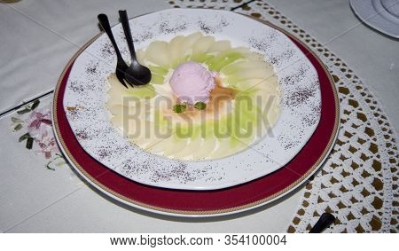 Beautifully Served Tasty Dessert On A Large Plate On A Reto White Tablecloth With Fruit
