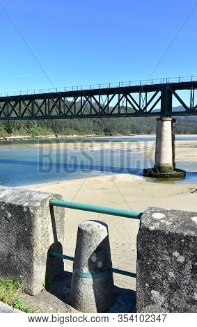 Beach With Forest And Two Train Bridges, Old One Used As A Promenade. Sor River, O Barqueiro, A Coru