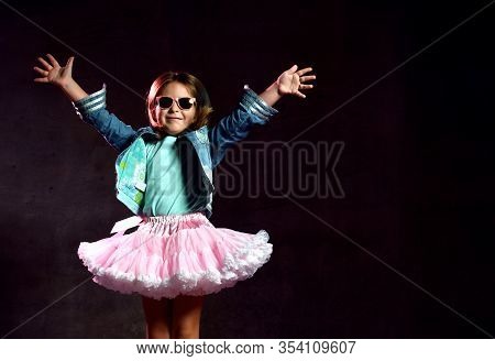 Little Girl In T-shirt, Denim Jacket, Poofy Skirt, Sneakers, Sunglasses. She Spreading Her Arms, Smi