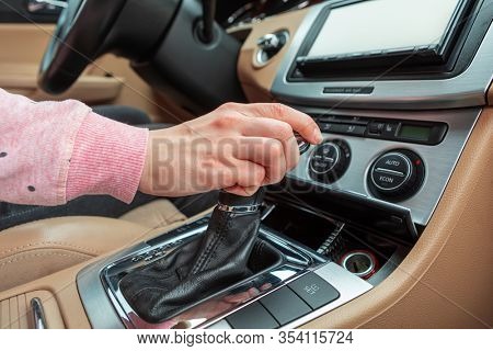 woman driver hand shifting the gear stick
