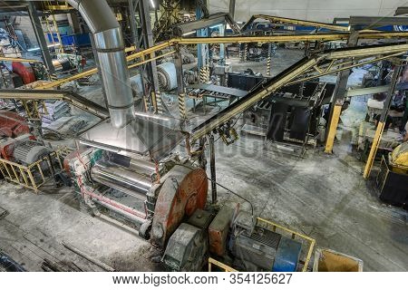 Interior Of A Factory For Manufacturing Rubber Conveyor Belts. The Workshop Is Filled With A Variety