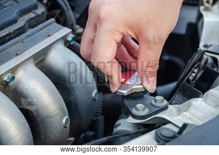 Man Hand Checking Level Of Coolant Car Engine. Check And Maintenance The Coolant In Car With Yoursel