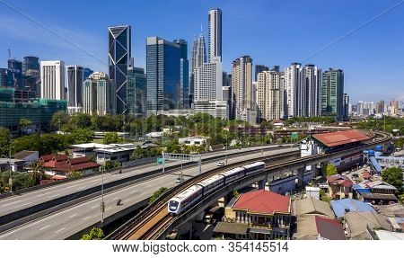 Kuala Lumpur Skyline With View Of Lrt And Blue Sky Background
