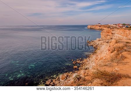 Black Sea Red Rocks Coastline. Cape Chersonesos Wild Beach In Sevastopol, Russia.