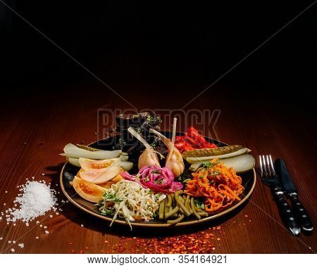Different Types Of Vegetables On Black Plate.