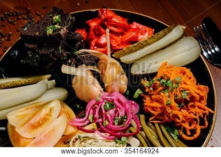 Different Types Of Vegetables On Black Plate.