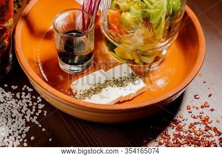 A Glass Teapot With Tea And A Glass Cup With Tea Stand On The Table