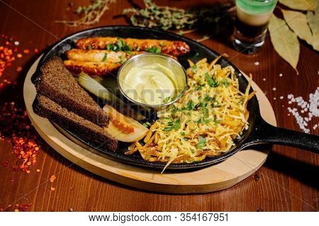 Fried Potato And Bavarian Sausage.german Food Concept