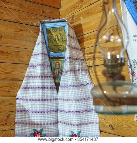 An Icon Depicting The Virgin Mary Of Our Lady, Decorated With A Towel With A Bedspread In A Wooden H
