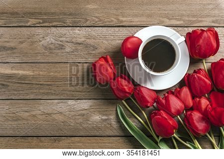 Row Of Red Tulips, Cup Of Black Coffee Americano On Wooden Background. Space For Text, Message. Moth