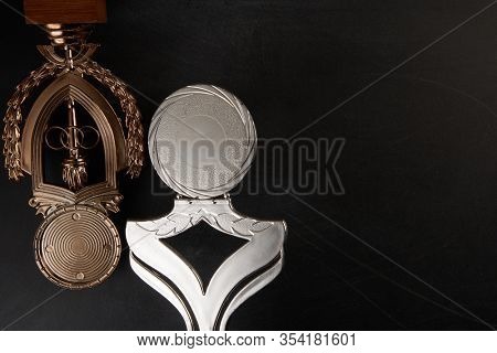 Golden trophy over blackboard background. top view. flat lay.Trophy is a specific achievement, serves as recognition / evidence of merit, awarded for sporting events