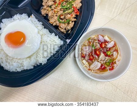 Rice Topped With Stir-fried Pork And Basil With Fried Egg And Chilli And Fish Sauce