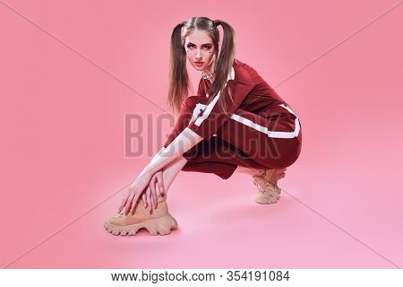 Fashion concept. Sport chic style. Full length portrait of a pretty girl in fashionable sportswear.