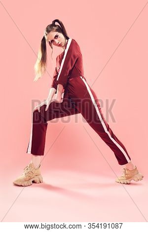 Fashion concept. Sport chic style. Full length portrait of a pretty girl in fashionable sportswear.