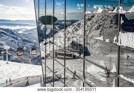 Demanovska Dolina, Slovakia - December 2: Reflection On Station Of Ropeway With Skis And Skiers At R