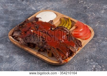 Turkish Doner With Veal On A Wooden Plate