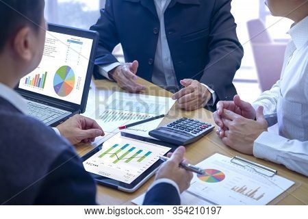 Businessmen Tab On Tablet Touch Screen To Deeply Reviewing A Diagram Or Chart And Financial Reports 