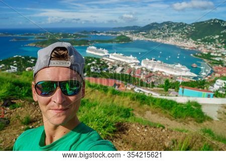 Three Cruise Ships In The Port Of St Thomas, Us Virgin Islands With Smiling Tourist Foreground