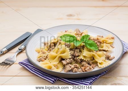 Ready-to-eat Pasta Navy With Minced Meat And Basil Leaves On A Plate On A Wooden Table. Russian Cuis