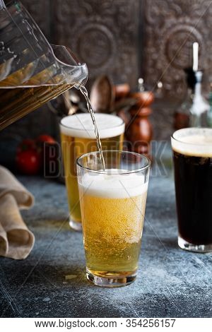 Assortment Of Beer In Tall Glasses Ina Rustic Setting