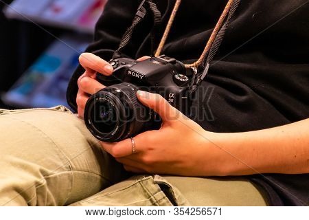 Puget-théniers, France - February 8, 2020: A Young Woman Holding A Sony Alpha 58 (slt-a58) Photo Cam