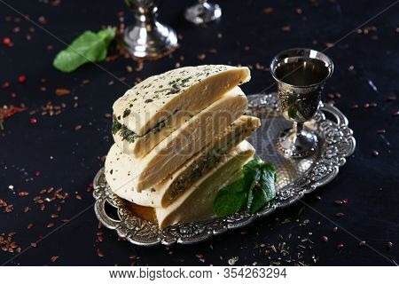 Halumi Cheese With Mint On A Vintage Tray With Vintage Silver-plated Accessories. Photo On A Black B
