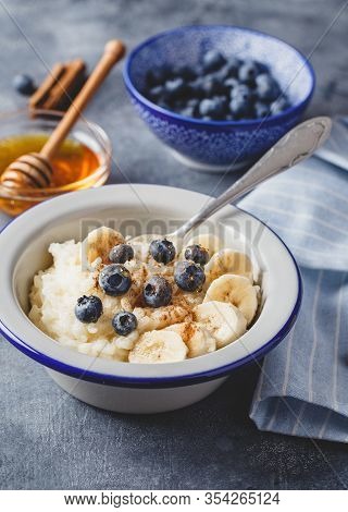 Milk Rice Porridge With Blueberry, Banana, Honey And Cinnamon, Creamy Rice Pudding Or French Riz Au 