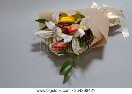 Close-up Fresh Spring Bouquet Of Tulip, Iris, Ruscus Gray Background, Selective Focus