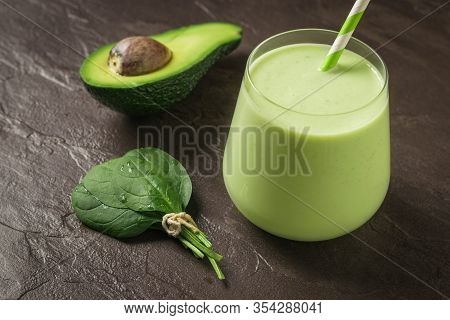 Glass With Spinach And Avocado Smoothies On A Stone Background. Fitness Product. Dietary Sports Nutr
