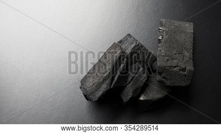 Black Wooden Charcoal On Black Background Top View