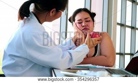 Female Doctor Suggesting Unhappy Chubby Woman To Eat Apple In Hospital Room.