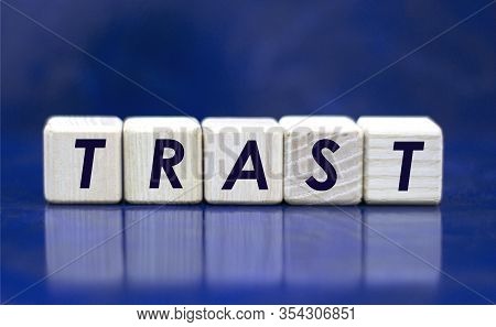 Concept Word Trast On Cubes On A Blue Background
