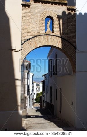 Archway With Statue And Alleyway Leading To The Plaza Del Carmen, Estepa, Seville Province, Andalusi