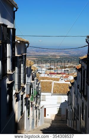 View Down A Steep Village Street Towards The Countryside, Estepa, Seville Province, Andalusia, Spain