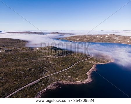 Aerial View. Road Crossing Hardangervidda Mountain Plateau, Clouds Over Lakes, Morning Time. Norway 