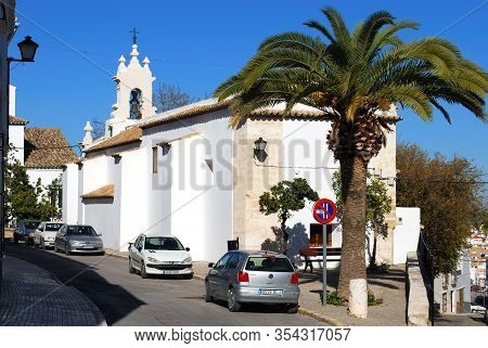 Estepa, Spain - November 13, 2008 - View Of Santa Ana Church With A Large Palm Tree In The Foregroun