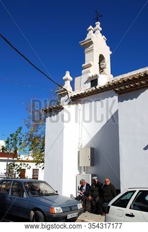 Estepa, Spain - November 13, 2008 - Elderly Spanish Men Sitting On A Bench Outside The Santa Ana Chu