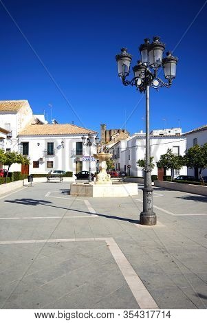 Osuna, Spain - November 13, 2008 - Iron Streetlight And Stone Fountain In The Town Square (plaza  Du