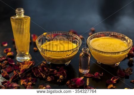 Close Up Shot Of Ghee And Rose Oil Face Mask In A Glass Bowl Along With Some Raw Ghee, Essential Ros