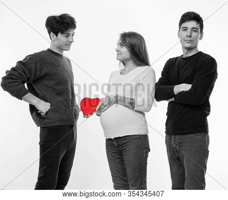 Young Pregnant Woman Posing With Two Young Man On A White Background