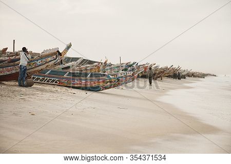 Kayar, Senegal - January 17, 2020: Traditional Painted Wooden Fishing Boat In Kayar, Senegal. Africa