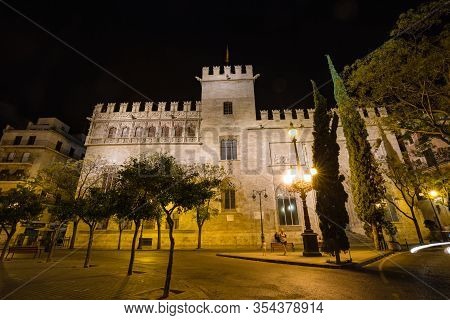 Valencia, Spain - October, 2019: Walking Night Streets Of Valencia Illuminated At Night. View Of Lon