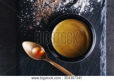 Beautiful Photo Of Golden Creamy Skincare Product In Big Elegant Black Glass Jar Near Golden Spoon W