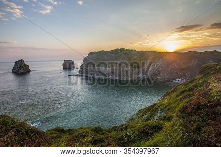Two Sisters At The Orange Sunrise In Hendaye In Winter, France
