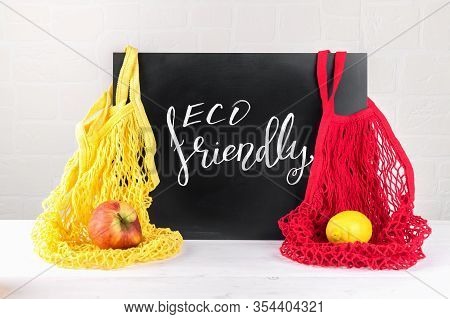 Lettering Eco Friendly, Message On A Black Chalkboard And Two String Mesh Cotton Bags With Apple And