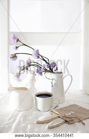 Festive Table Decoration For Easter. Coffee, Milk Jug And A Bouquet Of Blue Flowers In Jug, As Well