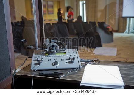 Interpreting - Microphone And Switchboard In An Simultaneous Interpreter Booth . Soft Focus Of Wirel