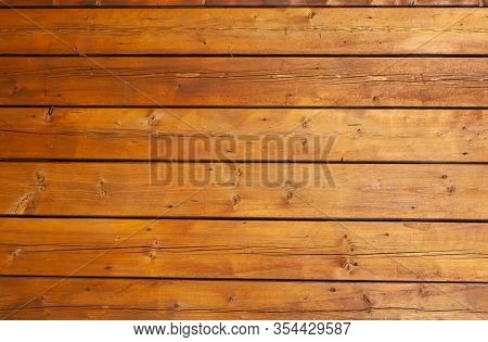 Stained wet deck wooden boards with water drops, brown planks texture